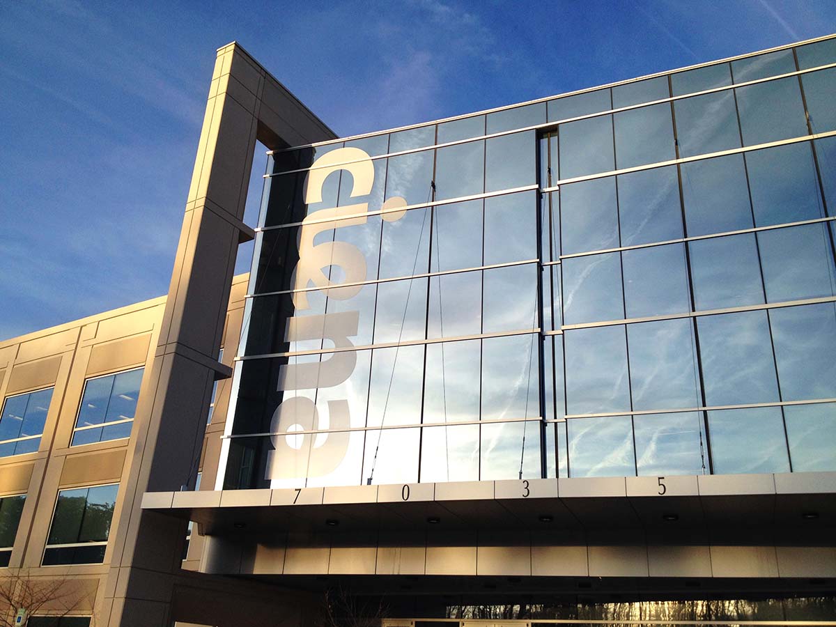 A modern office building with a glass facade, showcasing Ciena's headquarters under a clear sky.